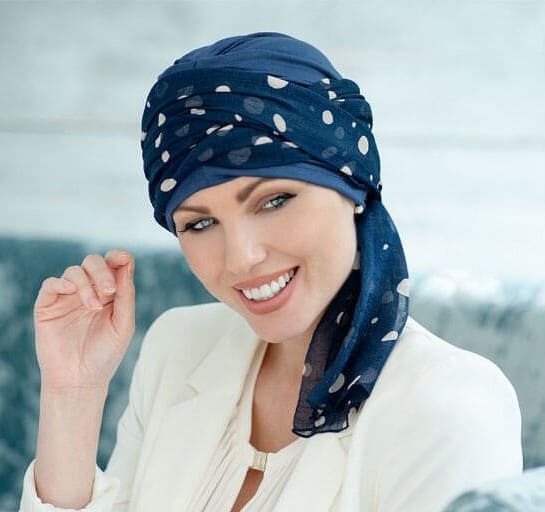 Woman with hair loss wearing a Daisy Hat with Full Scarf.