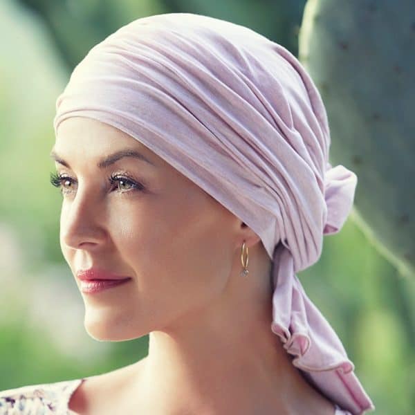 Woman with hair loss wearing Tula Soft Turban with Neck Cover made from soft bamboo with extra fabric to create volume with ties covering the nape of her neck