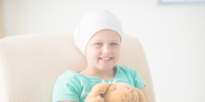 A child wearing a beanie hat due to hair loss caused by cancer treatment or alopecia