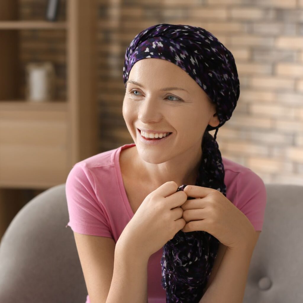 A lady wearing a cancer hair loss turban